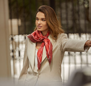 Model wears Sésam Motif Burgundy italian silk twill scarf around neck hailing cab